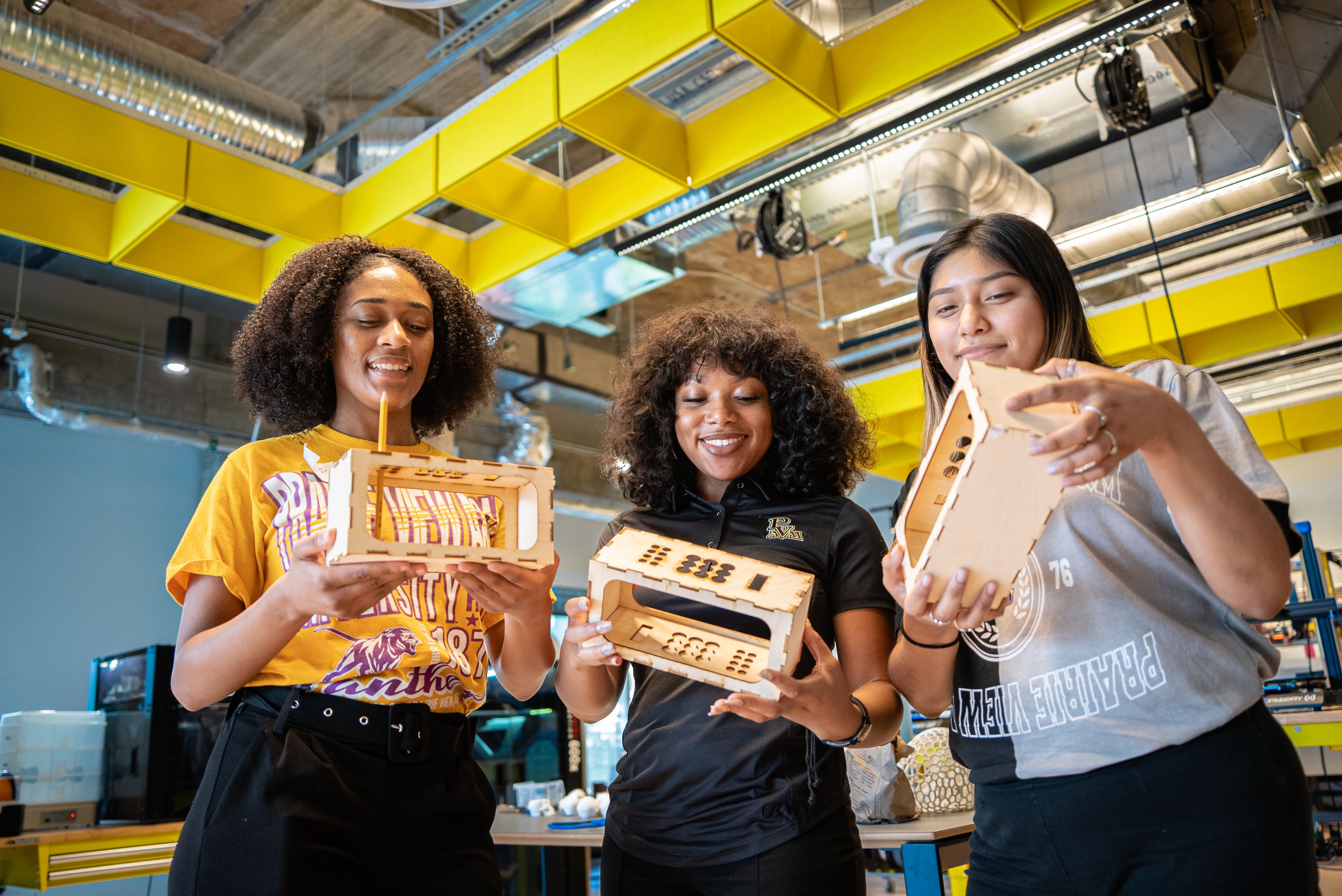 Three female students looking at a 3D model